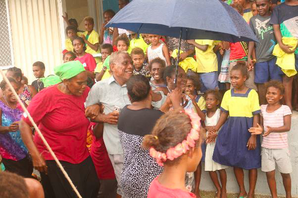 The former MPA Mr. Keith Amoasea is being pulled into the celeration dance by women and children