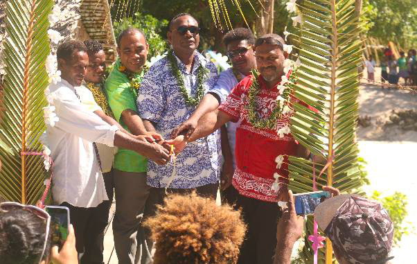 (L-R) Rara rep, Director MoFT, PS MECCDM, Premier Central, Ward Member, & PS MPGIS cutting ribbon to signify official opening of the Rara foot walk bridge. (L-R) Rara rep, Director MoFT, PS MECCDM, Premier Central, Ward Member, & PS MPGIS cutting ribbon to signify official opening of the Rara foot walk bridge.